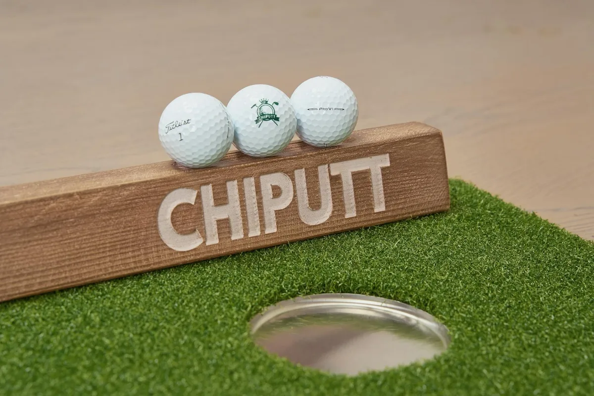 A collection of premium golf accessories and equipment laid out as gift ideas