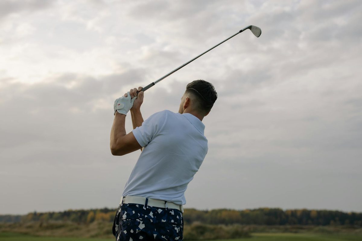 A golfer in a smooth, balanced follow-through position after a well-timed swing