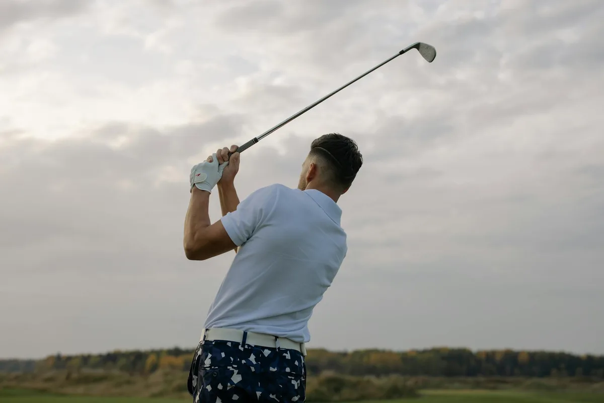 A golfer in a smooth, balanced follow-through position after a well-timed swing