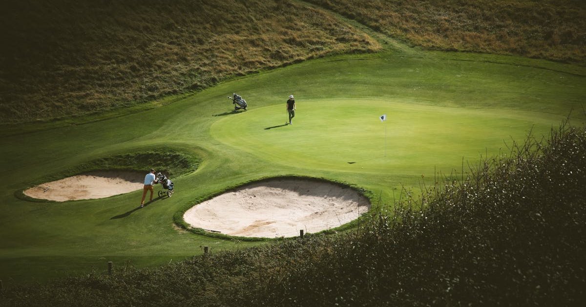 A well-maintained golf course in the south west of England with rolling hills in the background