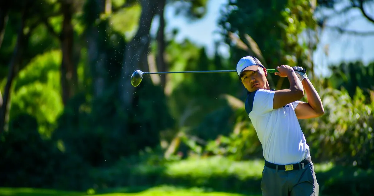 A golfer captured at the top of a powerful driver follow-through